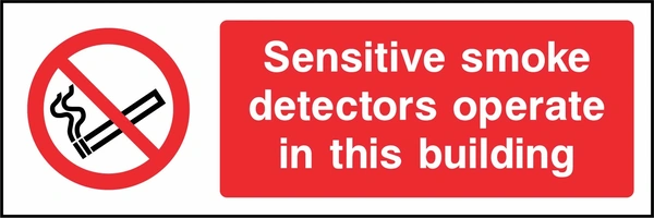 Sensitive smoke detectors operate in this building sign. red cigarette or naked-flame prohibition pictogram beside a red wording panel. Artwork SMOK0034.