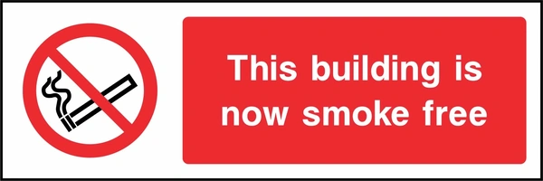 This building is now smoke free sign. red cigarette or naked-flame prohibition pictogram beside a red wording panel. Artwork SMOK0031.